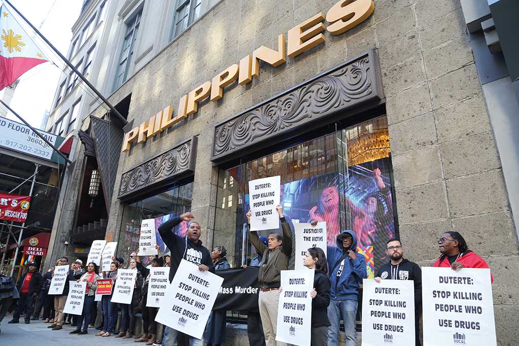 People protest in front of the Philippine Consulate General with posters